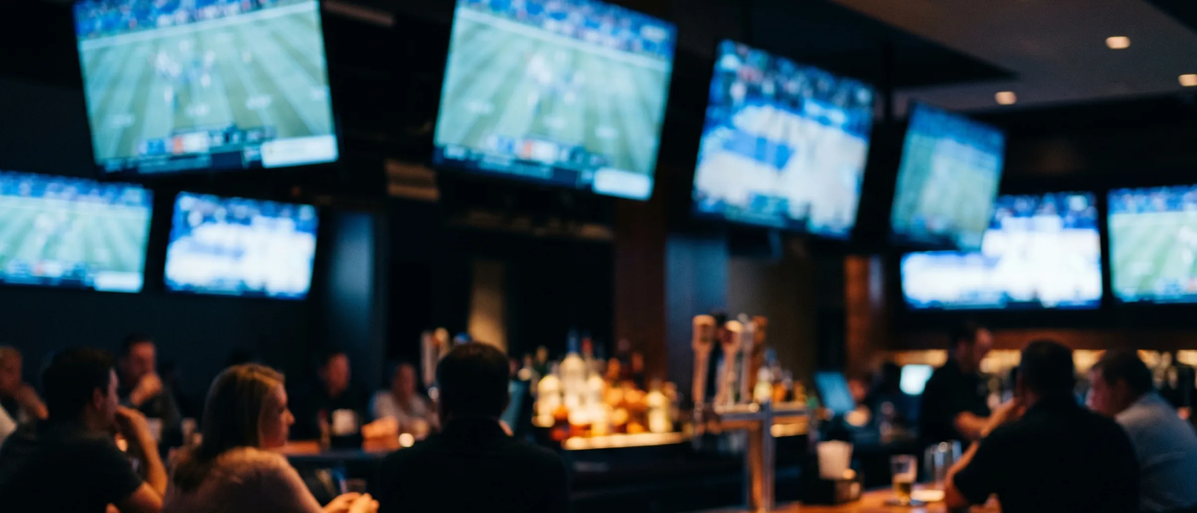 Bar interior at night with TVs